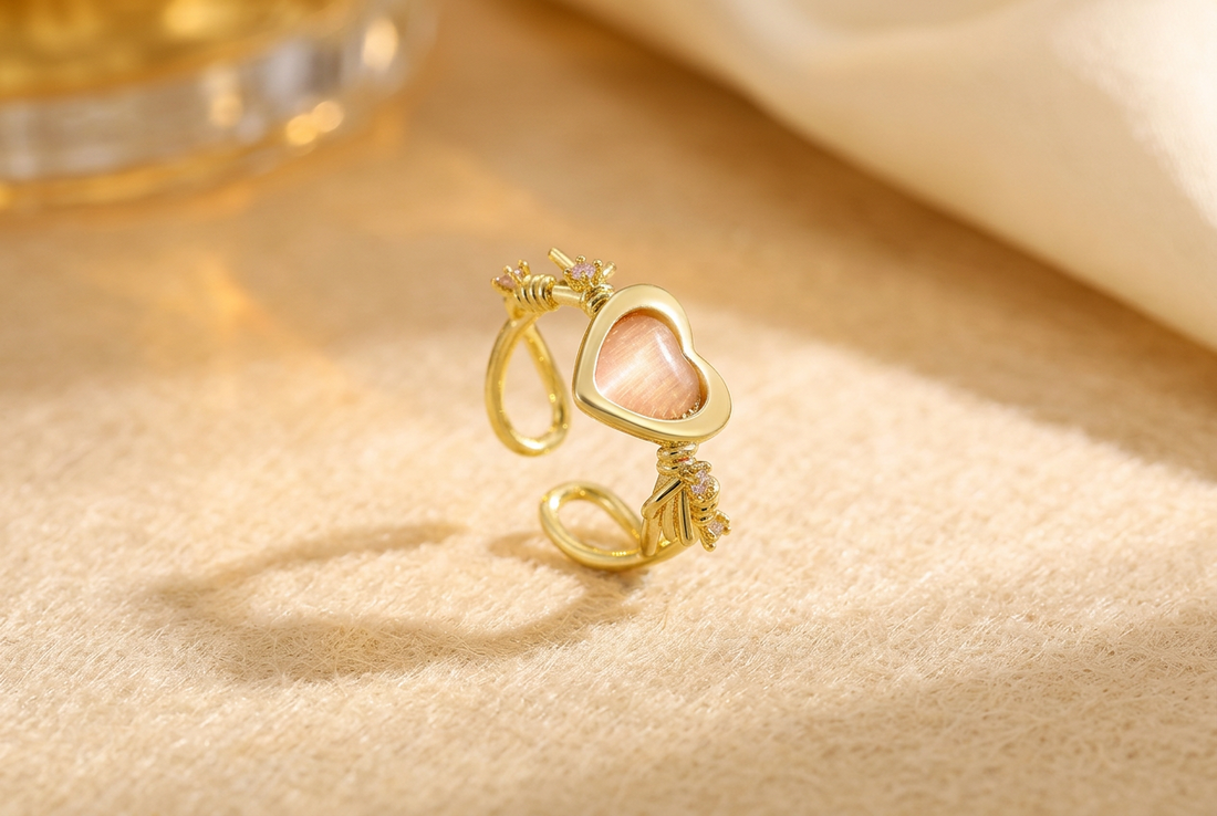 Anillo dorado ajustable con corazón rosa y detalles brillantes